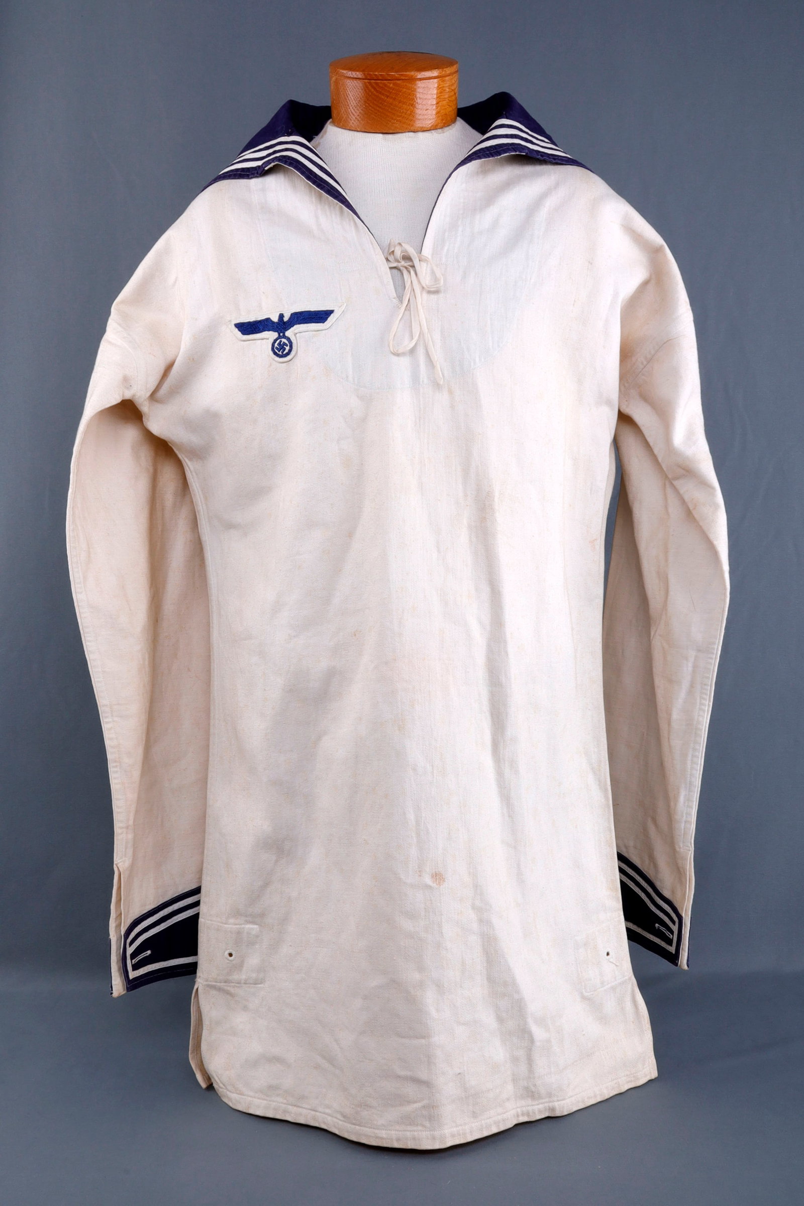 WWII KRIEGSMARINE TORPEDO MECHANIC NCO SMOCK 1936: Cotton twill uniform smock with embroidered eagle on right breast and torpedo mechanic's insignia on left sleeve. Interior has ink stamp "RAK 23.12.36 4" and embroidered mark "04532 38 S Baumgart. Rob