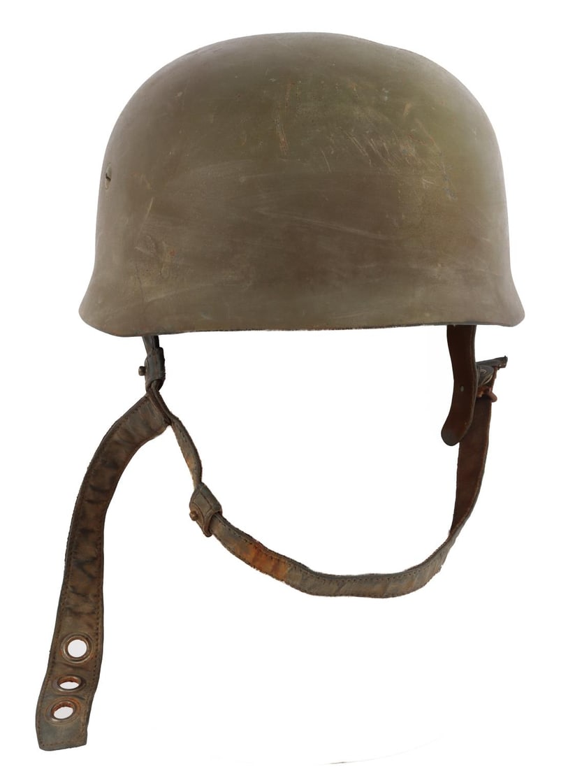 WWII GERMAN REICH FALLSCHIRMJAEGER HELMET M38: A fallschirmjaeger helmet of the German Third Reich. M38. Stamped internally 1299 for Eisenshuttenwerk Thale. ET71 on interior left side. Intact chin strap and liner. Paint consistent with the Normand