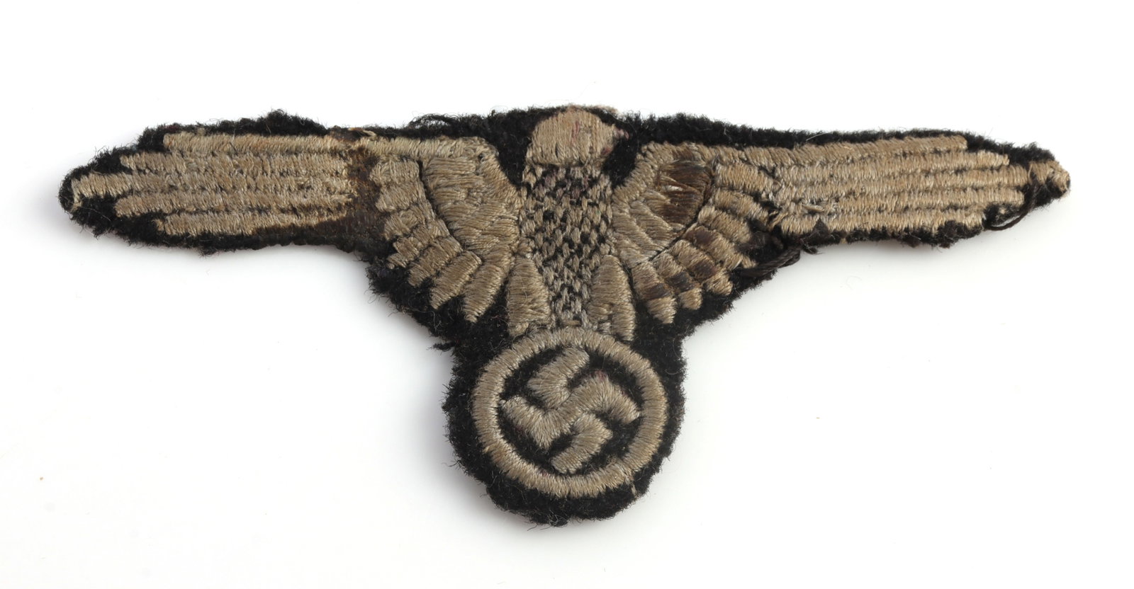 WWII GERMAN WAFFEN SS TUNIC REMOVED SLEEVE EAGLE: Third Reich Waffen-SS EM/NCO sleeve eagle insignia. Embroidered on black wool. Width 3.4 inches. Height 1.5 inches. Very good, original condition. This lot has a reserve.