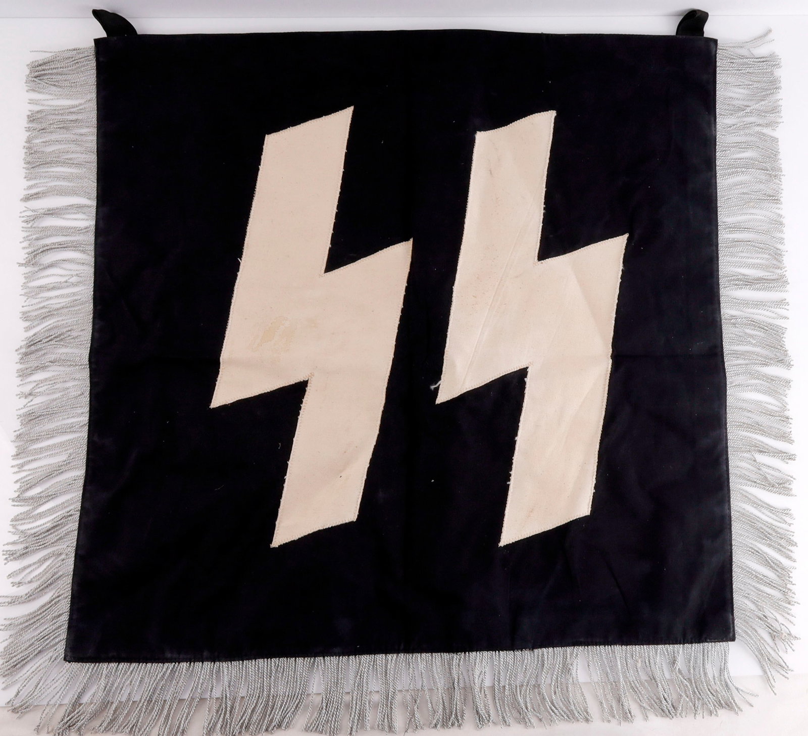 WWII GERMAN THIRD REICH SS WIKING DIVISION BANNER: Double sided machine sewn construction. SS runes on one side and sun wheel swastika on the other. Silver bullion thread. It measures 23 X 23 inches. This lot has a reserve.