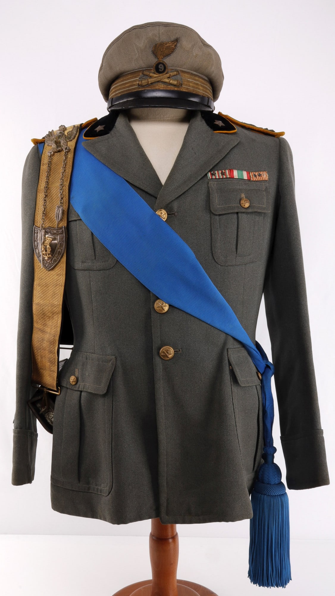 WWII ITALIAN FASCIST 9TH ARTILLERY OFFICER UNIFORM: Royal Italian Army 9th Heavy Artillery officer's dress uniform. Includes coat, visor cap, and silver-mounted grenadier bandolier belt with cartridge box. Coat has embroidered shoulder boards, azzurro 