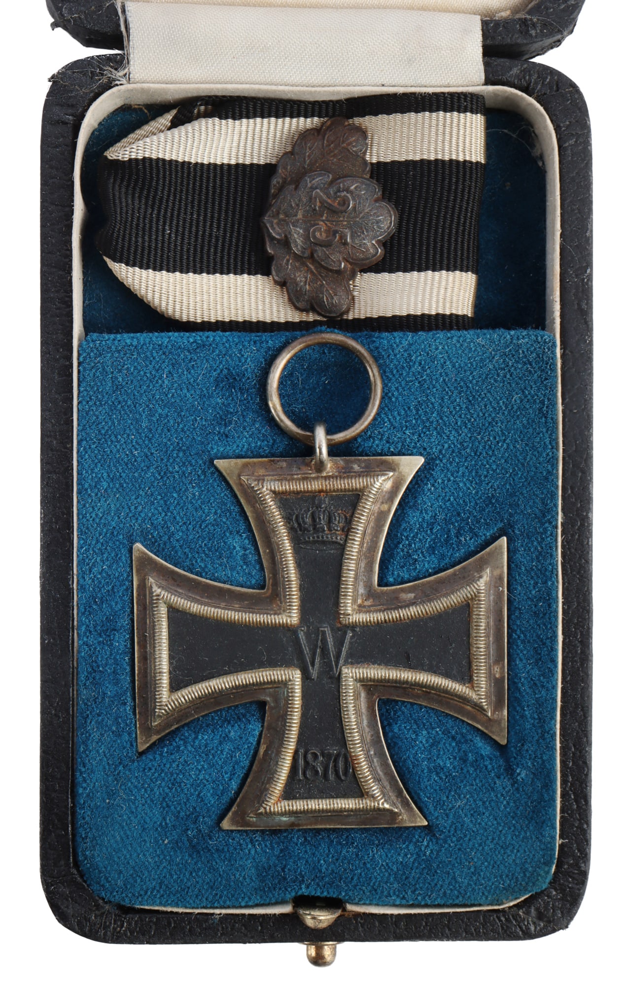 1870 IRON CROSS WITH 25 YEAR ANNIVERSARY OAK LEAF: Ribbon loop is marked SW for Sy & Wagner maker. Two piece construction with magnetic construction. Comes in a fitted case for cross and ribbon. Case is stamped. This lot has a reserve.