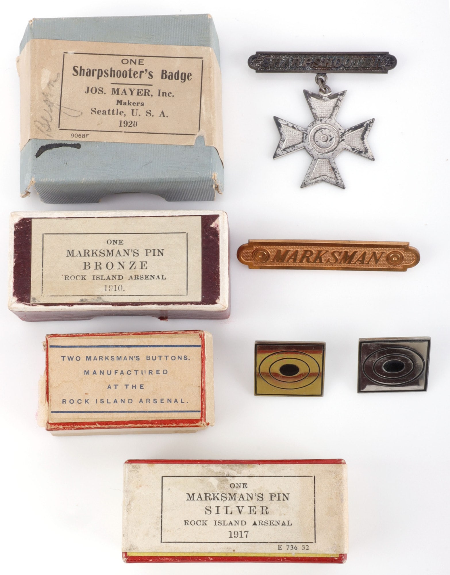 4 BOXED WWI DATED MARKSMAN BADGE LOT: Includes 1910 Marksman's pin, 2 Marksman's buttons, sealed in box ,1917 Marksman's pin in silver, and 1920 Sharpshooter's badge