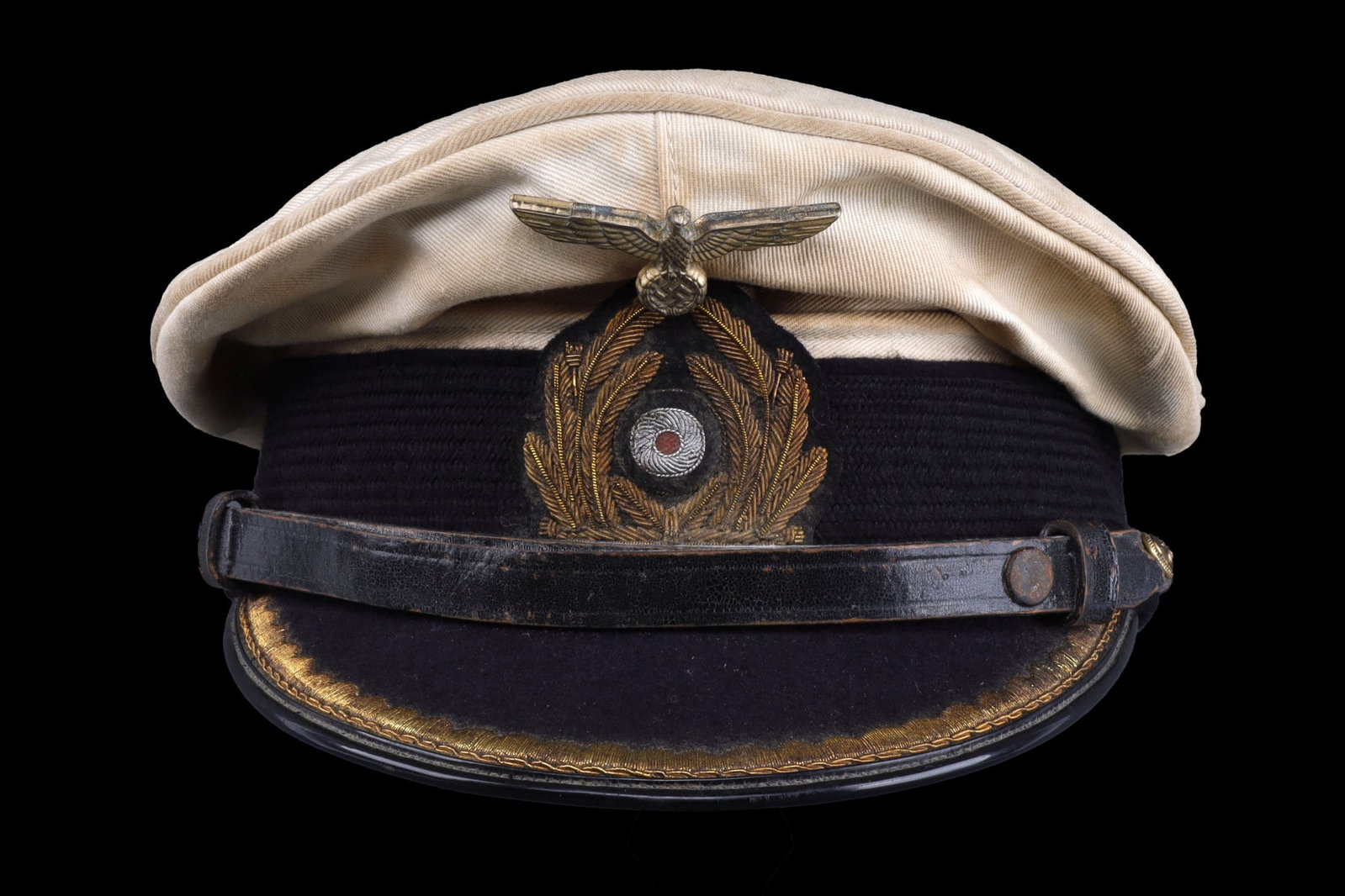 WWII GERMAN KRIEGSMARINE OFFICER VISOR: Cloth visor with removable cover. Eagle is gilt brass and constructed of zinc. Cockade is gold bullion as well as the border on the visor. Leather chin strap. Mostly stiff cellophane diamond. Overall 