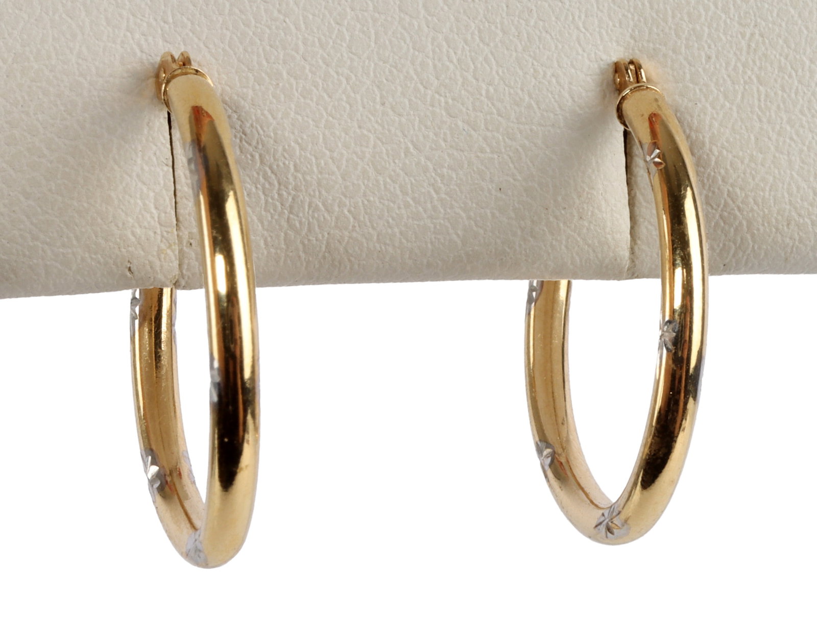 GOLD HOOP EARRINGS WITH STARBURST ETCH: Two gold hoop earrings, lined with starburst etchings. .9 grams total. Very good, original condition. This lot has a reserve.