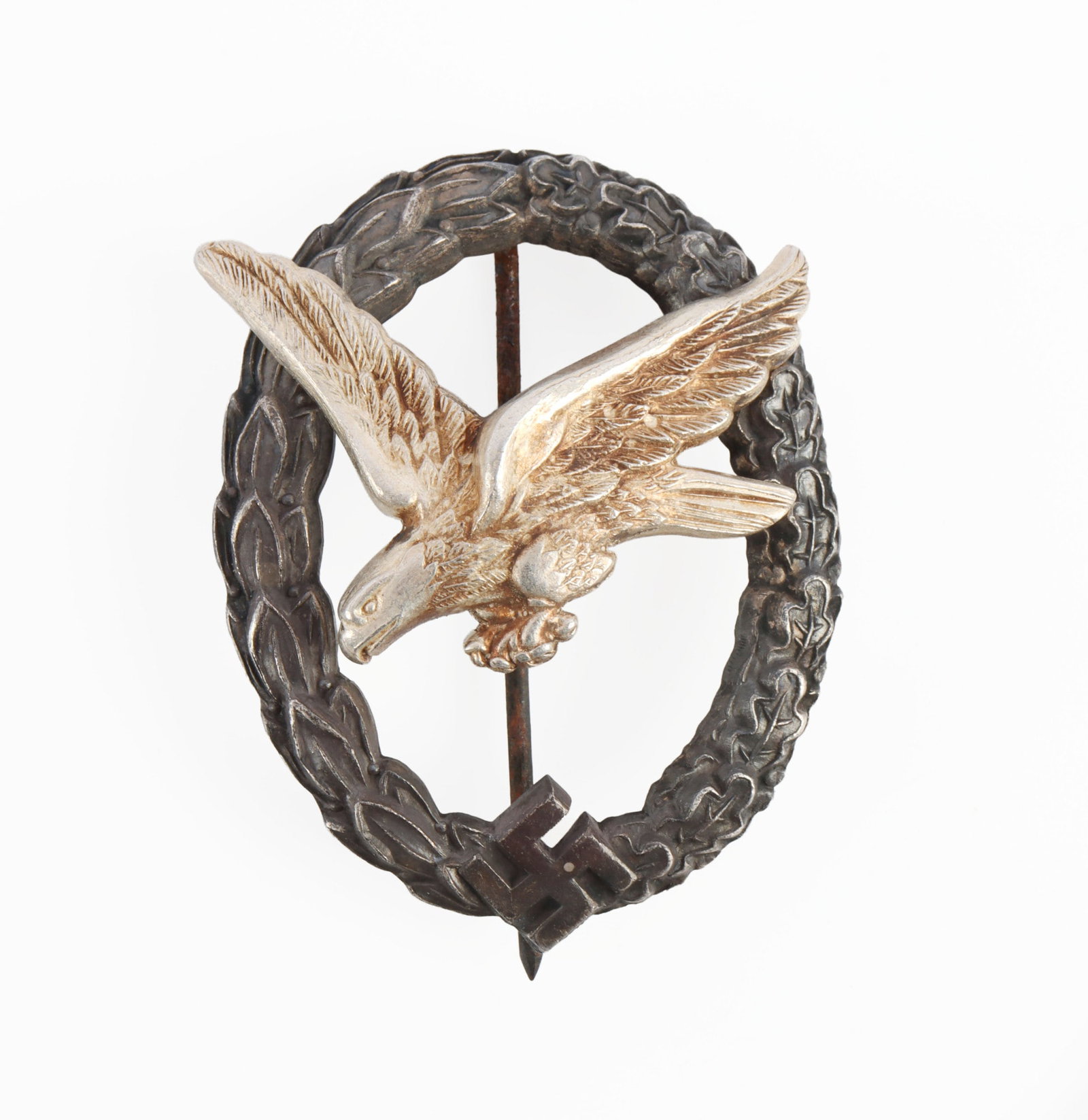 WWII GERMAN LUFTWAFFE AIR GUNNER BADGE: Unqualified air gunner badge. Silvered eagle and oak leaf wreath. Both toned. P Meybauer make. It measures 2 inches. Very good condition. Pin is slightly stiff due to age. This lot has a reserve.