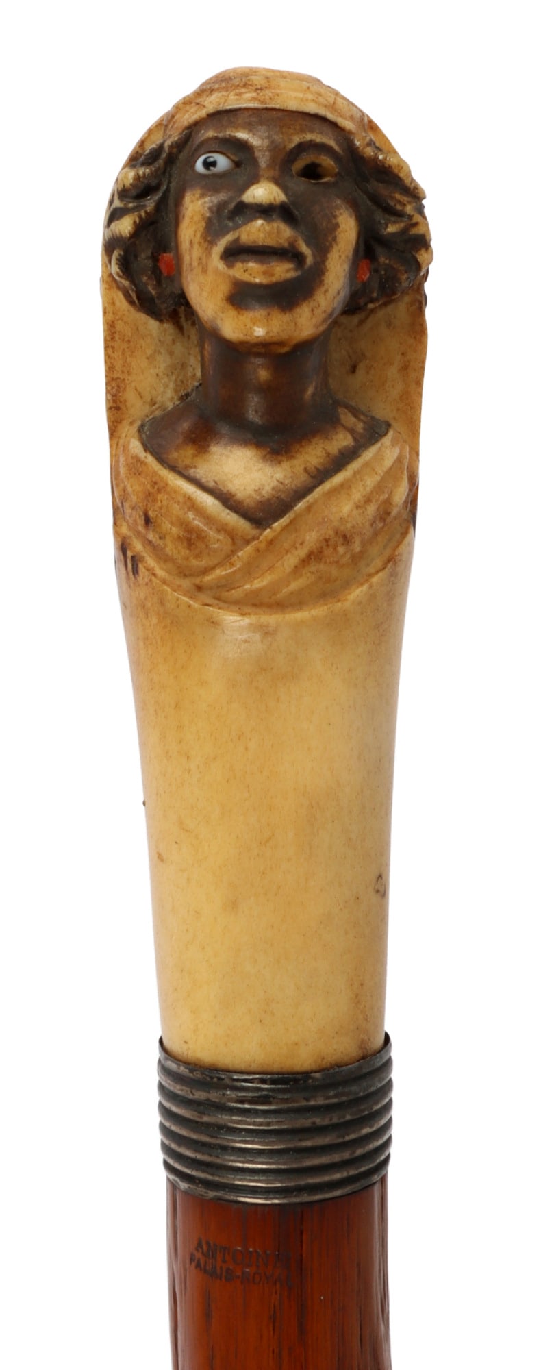 ANTOINE PALAIS ROYAL ANTLER GRIP WALKING CANE: Antler grip with a woman carved into it. Shaft is wood. Nickel ferule. It measures 36 1/4 inches.