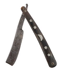 STRAIGHT RAZOR WITH SILVER INLAY HANDLE: A straight razor with a silver inlay handle. Blade stamped warranted. Very good, original condition.