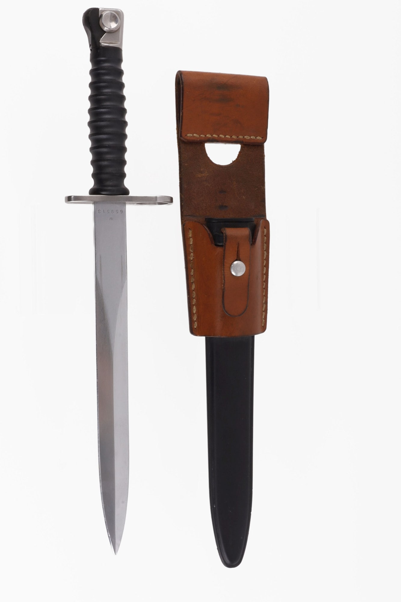 SWISS MODEL 1957 BAYONET WITH FROG & SCABBARD: A Swiss model 1957 bayonet. Stamped 'W 659513' on one side of ricasso, F+W mark on other side. 9.5 inch blade, sheathed total item length is 15 inches. Frog is etched "J. Fuchs Riehem 86.' Very good,