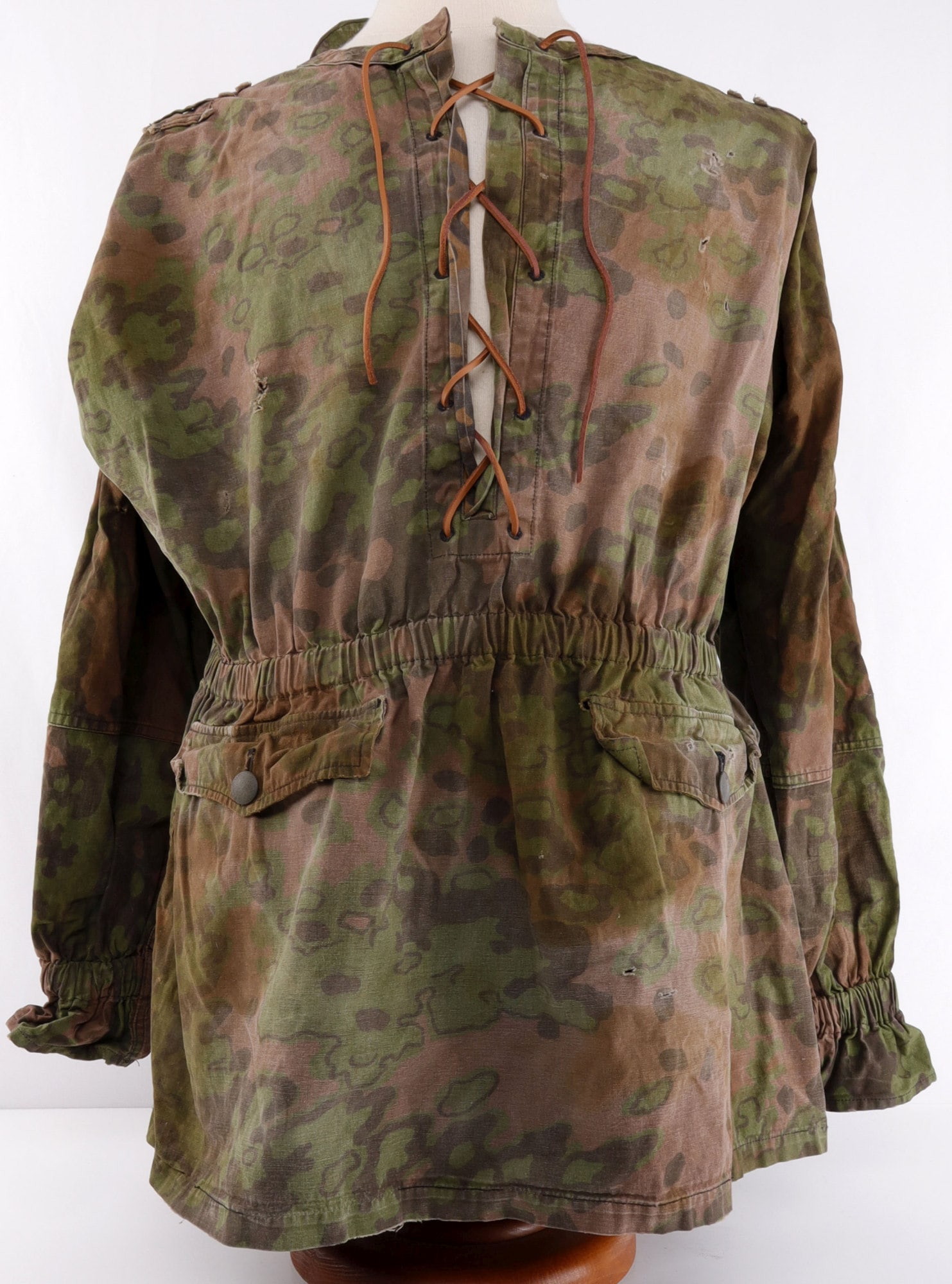 WAFFEN SS SMOCK OAK CAMO BLOUSE WWII GERMAN: Standard issue, reversible smock. 31 inches from collar to tip of sleeve. 40 inches from collar to base. Very good condition overall. Some staining and fading. Non-fluorescing. From featured dealer Jo