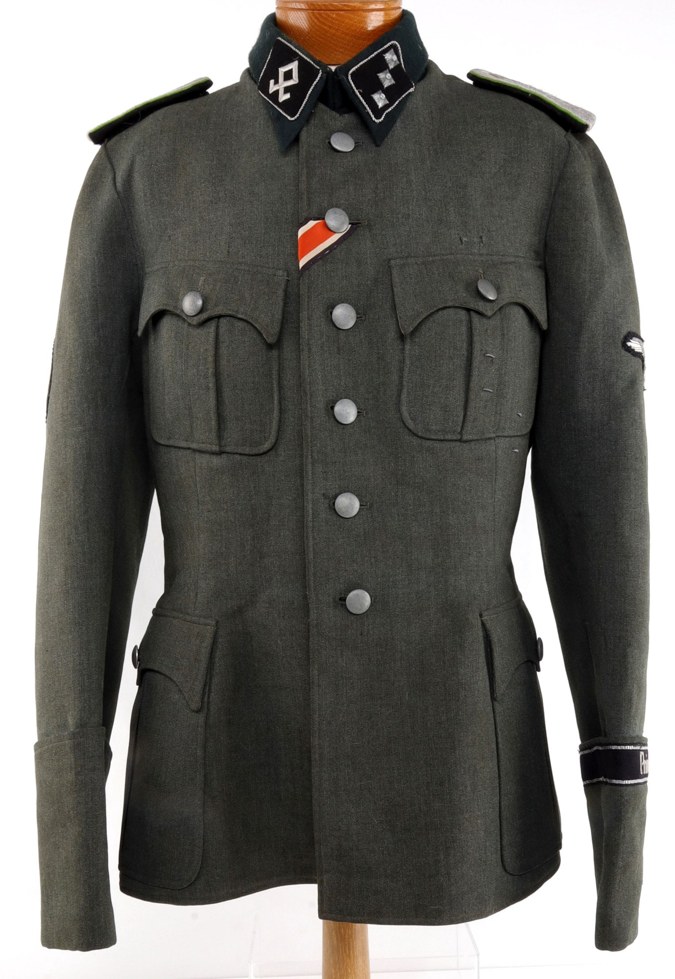 WWII SS 7TH VOLUNTEER MOUNTAIN DIVISION TUNIC: WWII German Prinz Eugen 7th Volunteer Mountain Division. Dark green collar with embroidered collar tab for 7th Division. Three pips for rank. Shoulder boards with green border. Pebbled buttons marked 