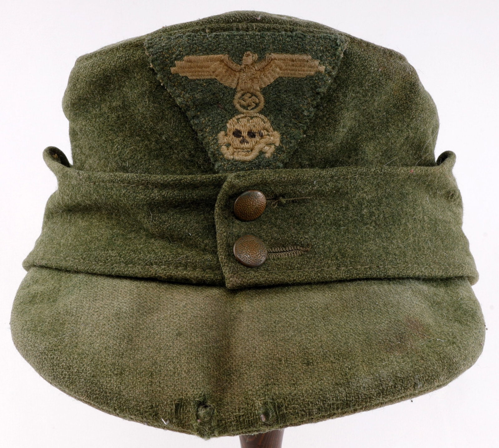 SS MODEL 43 FIELD CAP WWII GERMAN THIRD REICH: A model 1943 field cap for the Waffen-SS. Dimpled metal buttons. Non-fluorescing. Interior and external wear consistent with use. Small size. Very good, original condition. From featured dealer John F