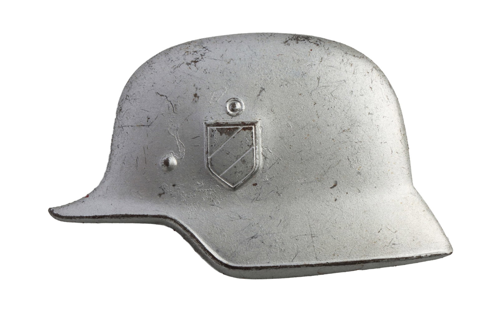 DER STAHLHELM DECAL WWII GERMAN THIRD REICH: A small metallic decal depicting a Stahlhelm, likely for the organization Der Stahlhelm or a similar right-wing militia organization in the post-WWI era. 2.5 inches wide. Very good, original condition