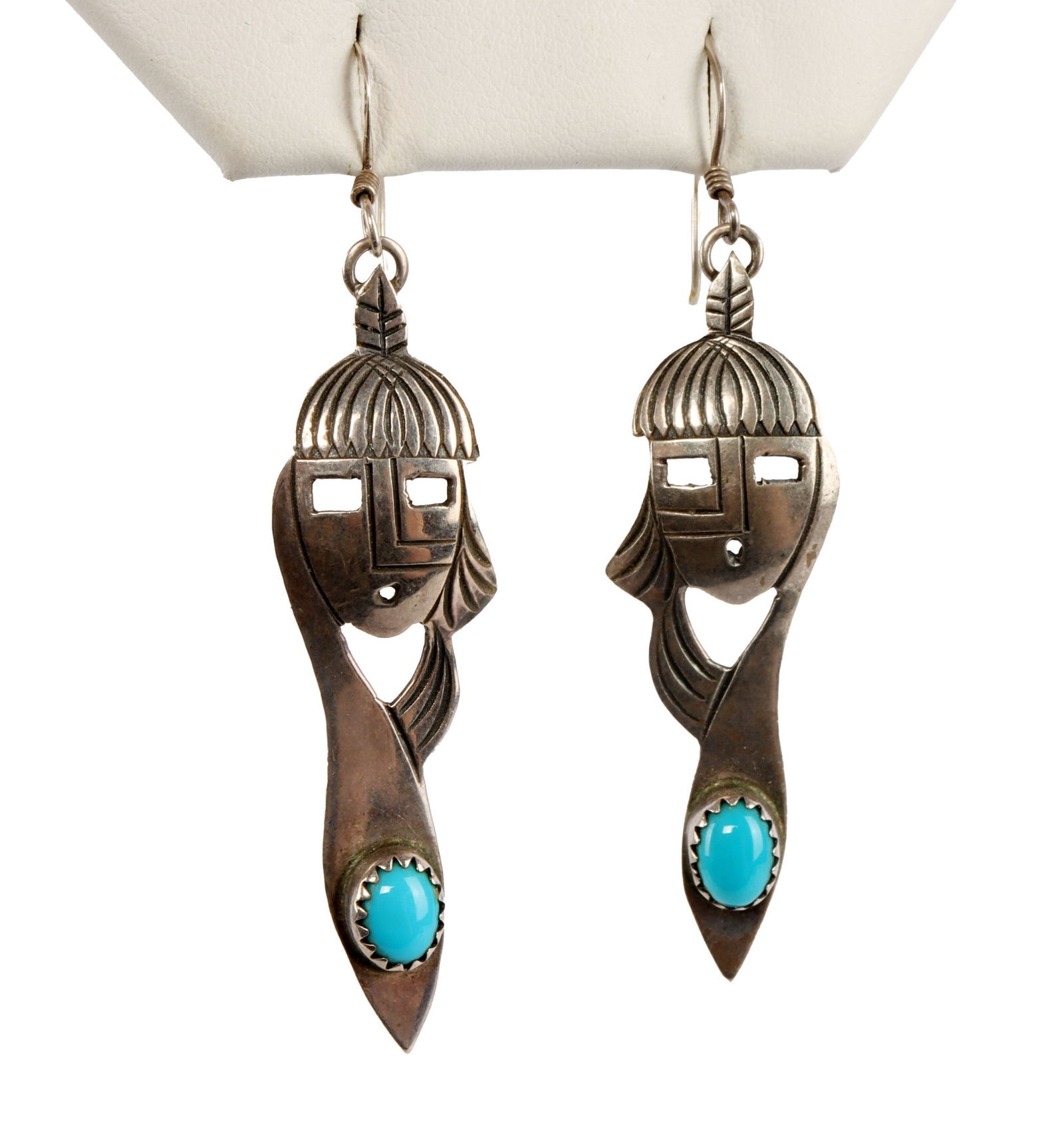 NATIVE AMERICAN ZUNI SILVER AND TURQUOISE EARRINGS: Pair of sterling silver face motif earrings with one Arizona turquoise stone on each earring. Likely Zuni. Measures 2 1/2 inches (including hook). Very good, original condition. This lot reserved at m
