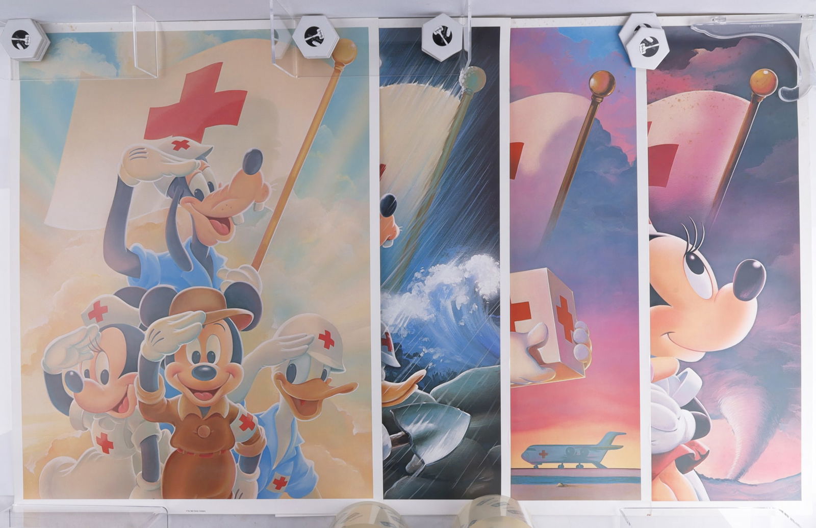 HURRICANE ANDREW MICKEY MOUSE PRINT SUITE LOT 4: Four posters depicting classic characters from Walt Disney as members of the Red Cross. Characters include Mickey, Minnie, Goody, and Donald. These posters were produced by legendary Disney artist Don
