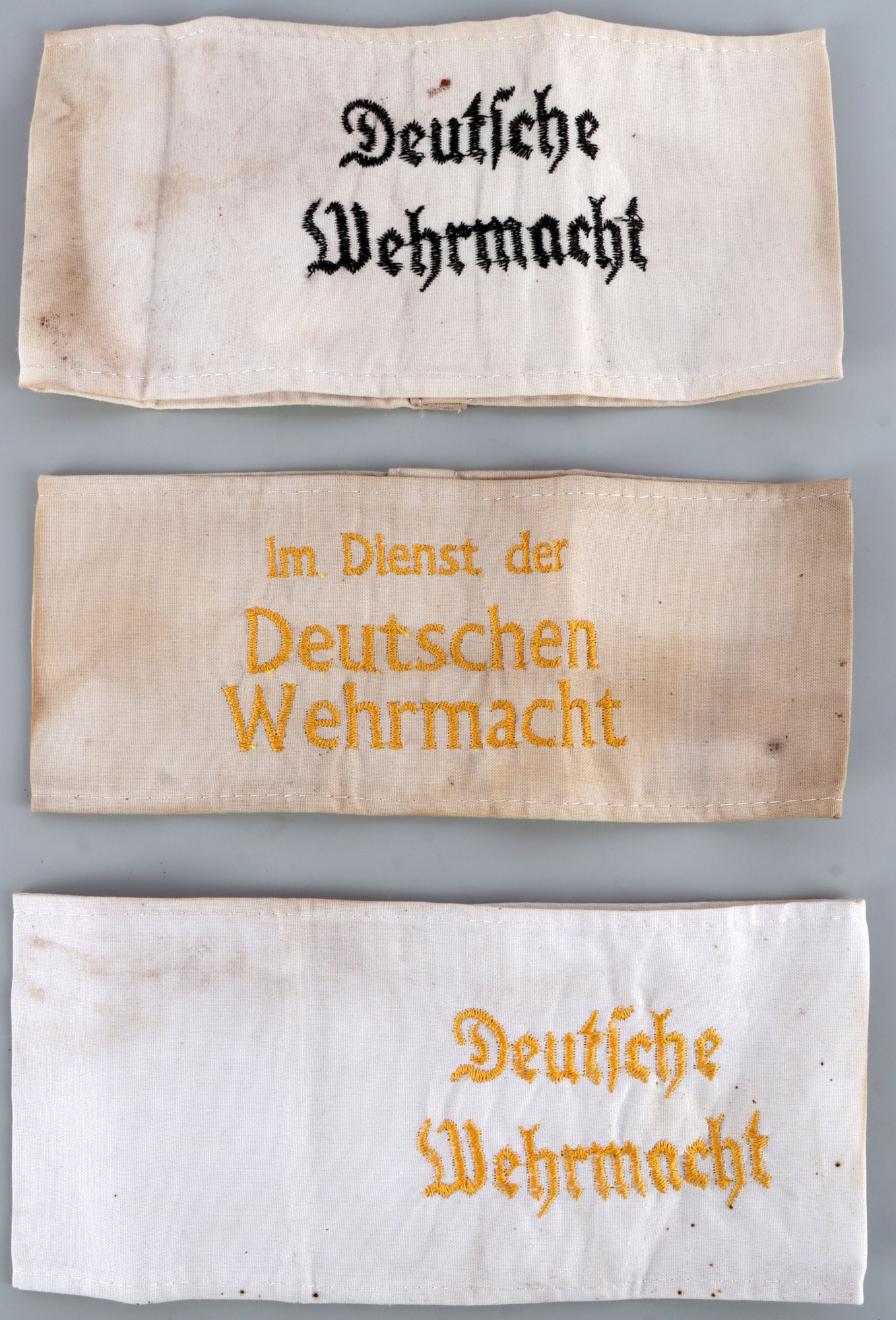 WWII GERMAN REICH ARMBANDS LOT OF 3 WEHRMACHT: Three armbands, all associated with the German Wehrmacht. All fluoresce. Unauthenticated, sold as is.