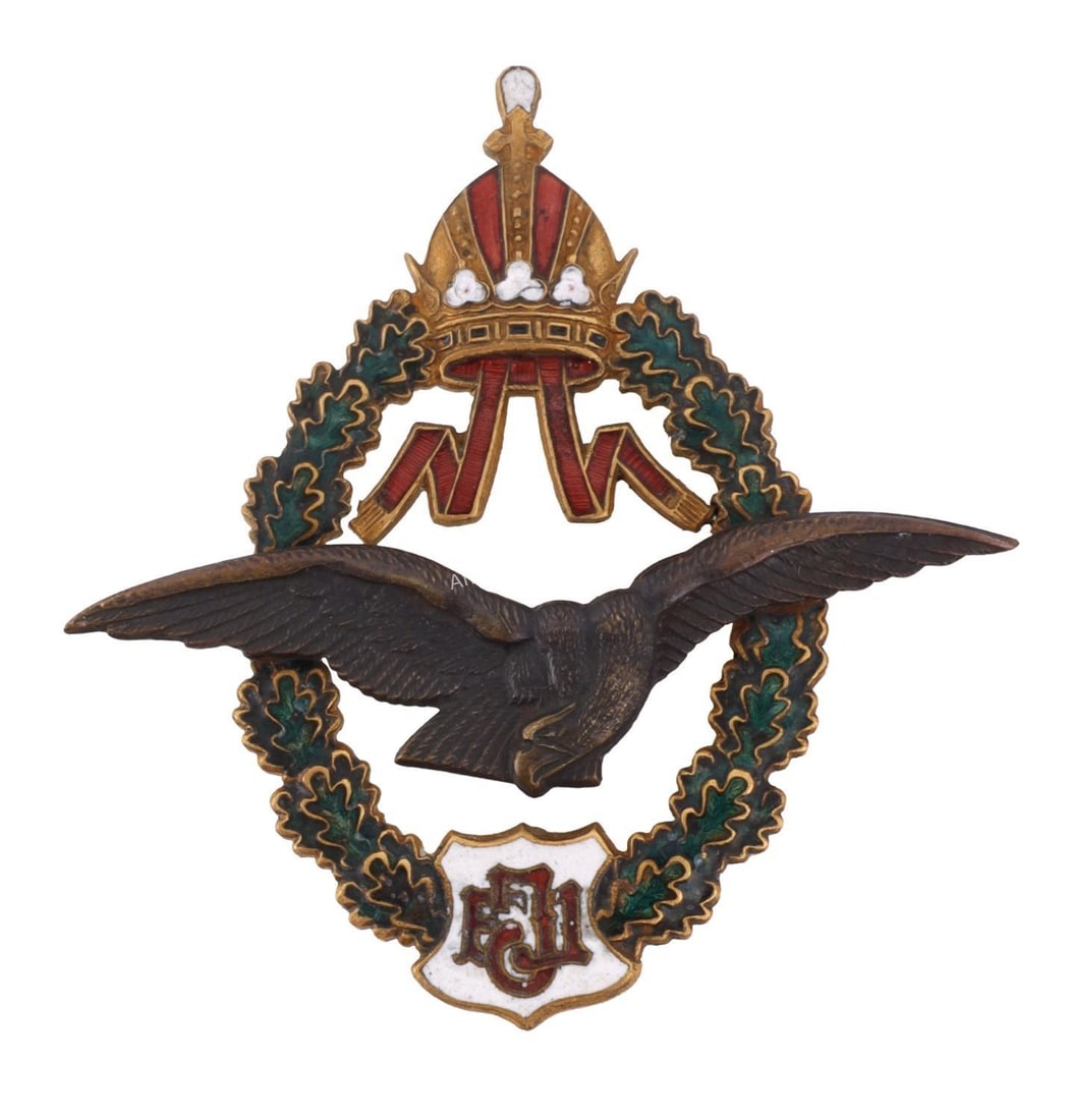 WWI AUSTRIAN EMPIRE PILOT BADGE: Brass badge with green and red enamel. J. Simbler Wien. It measures 2 7/16 inches This lot has a reserve.