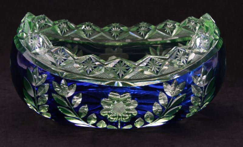 BOHEMIAN CZECH COBALT CUT TO CLEAR CRYSTA L BOWL: A wonder piece of vintage Bohemian colbalt blue "cut to clear" crystal. Centerpiece is 10 inches long 6.5 inches wide and 5 inches tall. No makers marks or labels. Floral with leaf pattern. Minor flea