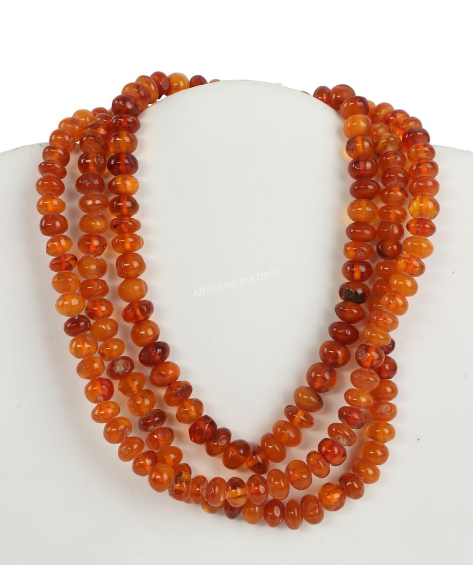HINDU MALA PRAYER BEADS MADE FROM BALTIC AMBER: Set of Hindu mala prayer beads, divisible by nine, carved from Baltic amber. Piece shows evidence of both use and age, with uneven wearing and some cracks in a few beads. 50 inches all around. Very go