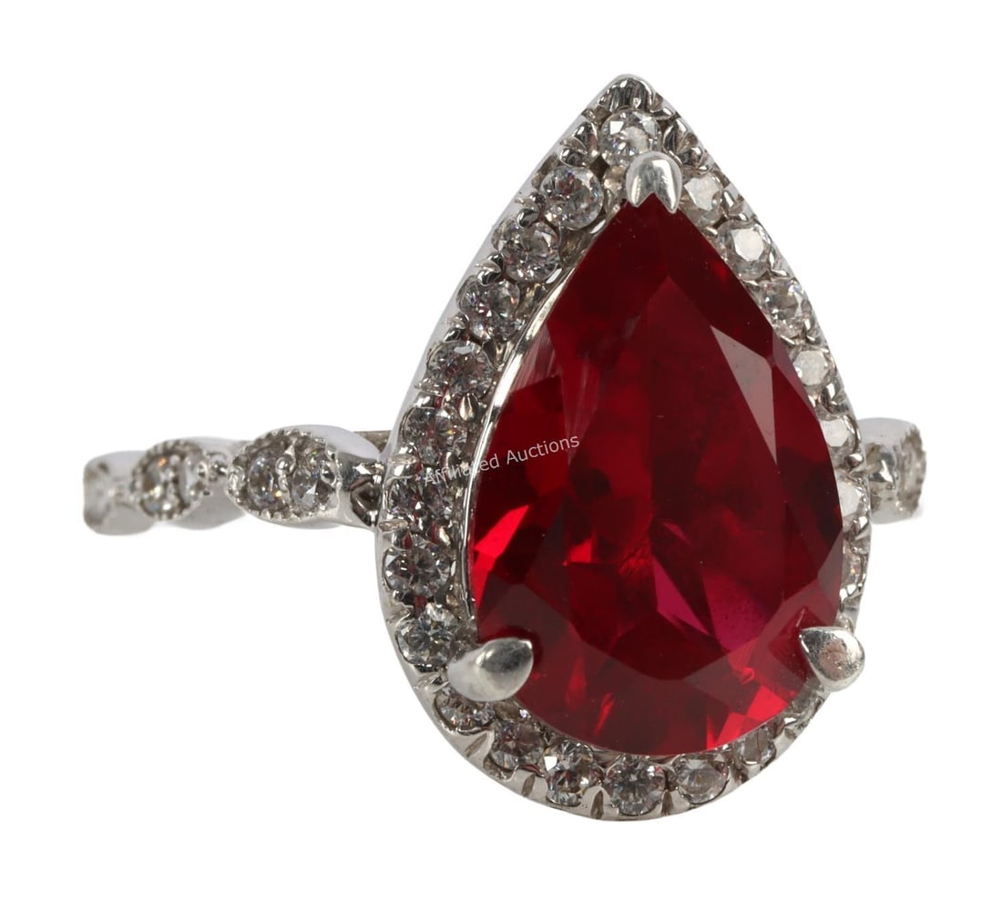 .925 SILVER RING WITH RED TEARDROP GEMSTONE: A .925 silver ring with a red tear drop gemstone. Size 8. Very good, original condition.