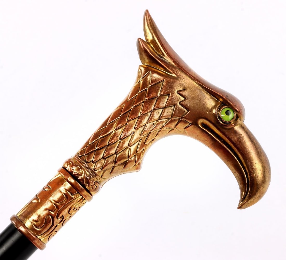 CANE SWORD WITH BRONZE GILT BIRD HEAD HANDLE: Bronze gilt bird with green eyes for handle measuring 4 1/2 inches. Length of cane measures 35 1/4 inches.
