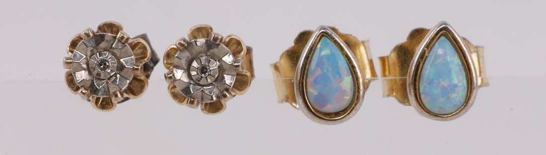 STERLING SILVER GOLD TONE EARRING LOT OF 2: Two pairs of sterling silver earring gold tone. Both are studs one pair has blue opal the other has moissanite. Stamped 925. In very good condition. This lot has a reserve.