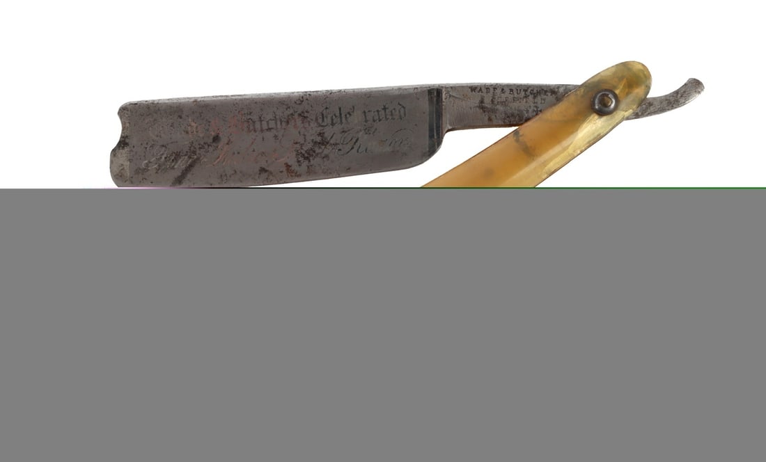 ANTIQUE STRAIGHT RAZOR WADE & BUTCH: An antique straight razor with the slogan 'Wade & Butch's Celebrated Fine India Steel Razor' embossed on to the blade. Approximately 6 inches when folded.