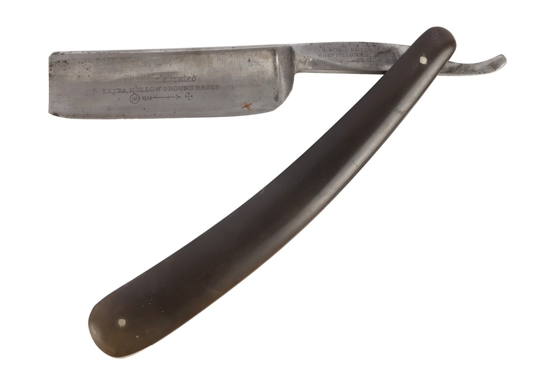 ANTIQUE STRAIGHT RAZOR WADE & BUTCH: An antique straight razor with the slogan 'The Celebrated Hollow Ground Razor' embossed on to the blade. Approximately 6 inches when folded.