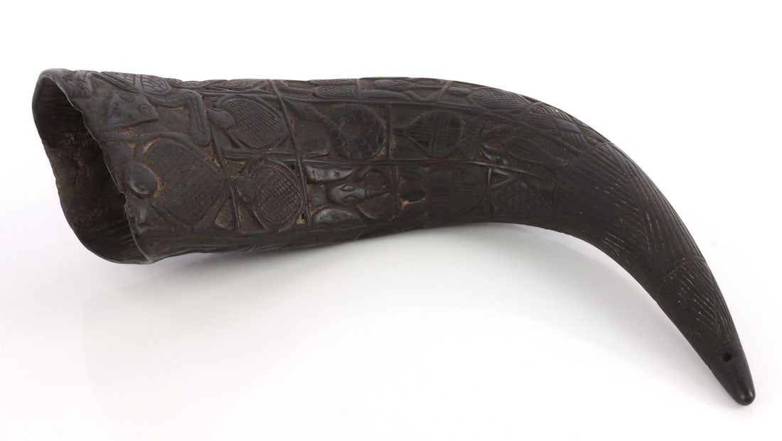 AFRICAN INTRICATELY CARVED COWHORN ANIMAL DESIGNS: An intricately carved cow horn, African in nature. Spider and elephant design indicates Congolese, though carved images range from pipes to turtles. 15 inches along the curve.