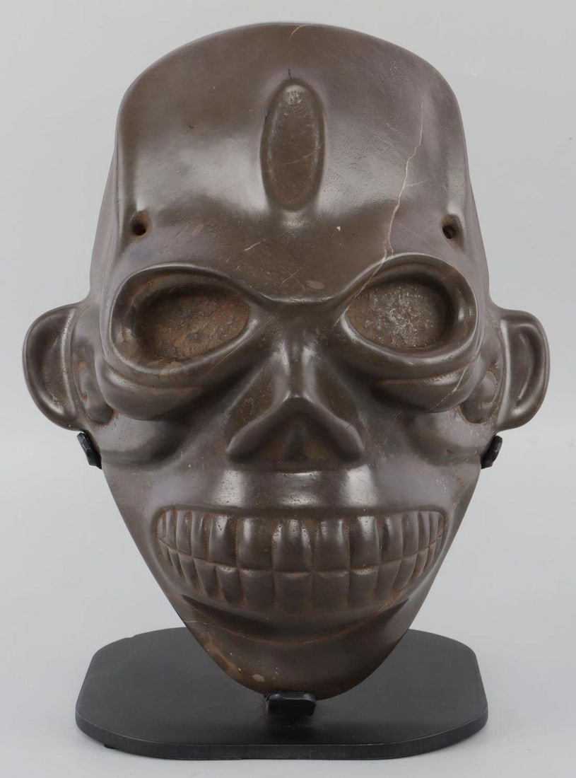 TAINO PRECOLUMBIAN PUBLISHED CARVED HEAD: Exceptional carved head depicted with tabular oblique skull modification. An exceptionally expressive face with broad dominating forehead. Deep set eyes with highly embossed eye margins stare at the v