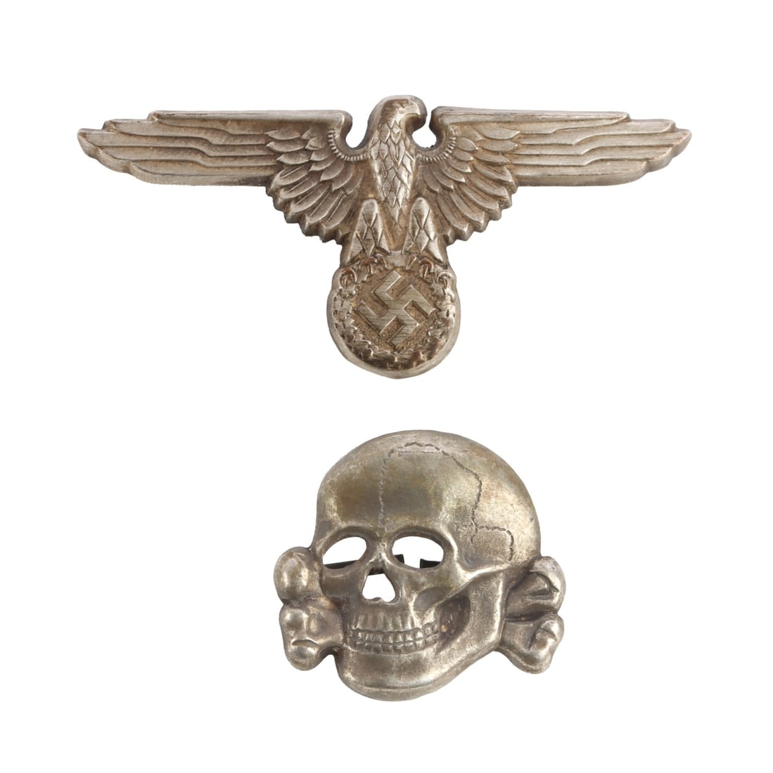 WWII GERMAN THIRD REICH SS VISOR PIN SET: SS Visor Hat Set. Eagle marked M1/8 (Wiedmann); Skull marked D.S. & M. (Deschler & Sohn). They measure 2 5/8 and 1 1/16 inches. Very good condition. This lot has a reserve.