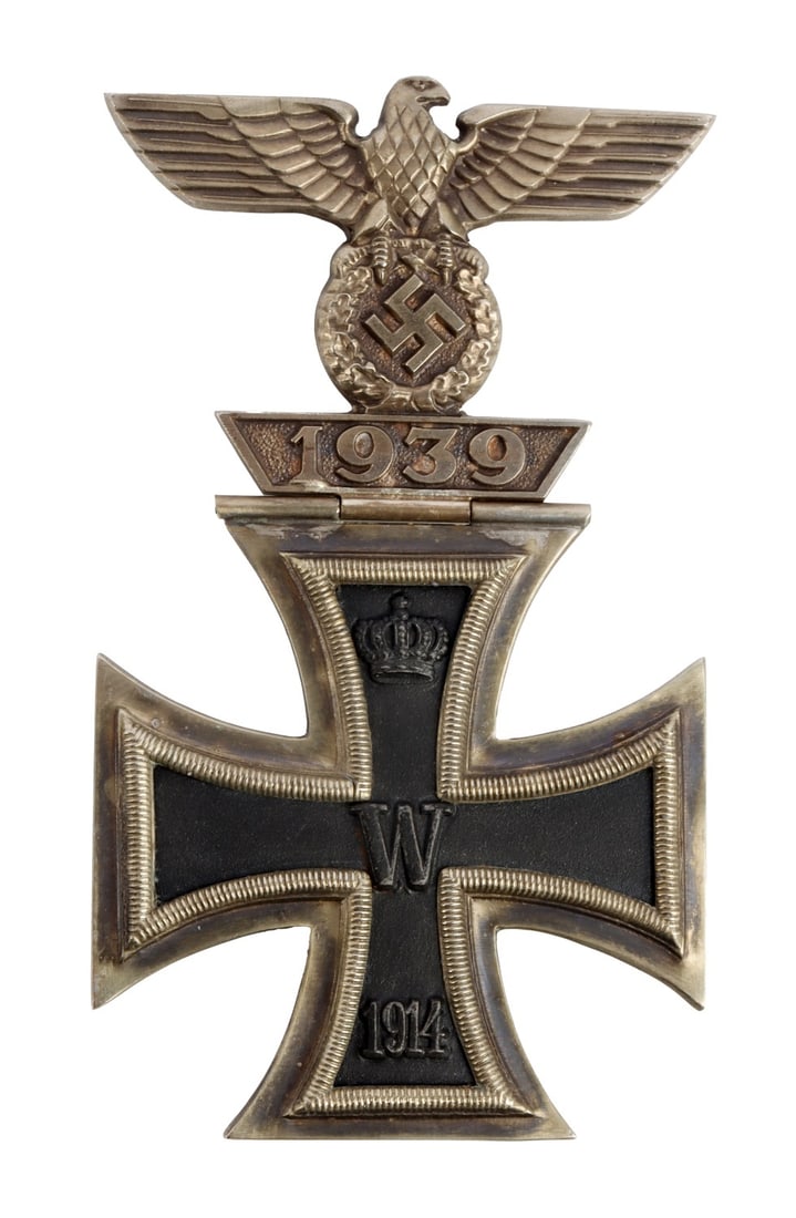 GERMAN WWI IRON CROSS WITH 1939 SPANGE: A 1914 Iron Cross 2nd Class with a 1939 Clasp (Spange) attached via a rare hinged needle and top hook support. All components stamped L/56. The cross is magnetic This lot has a reserve.