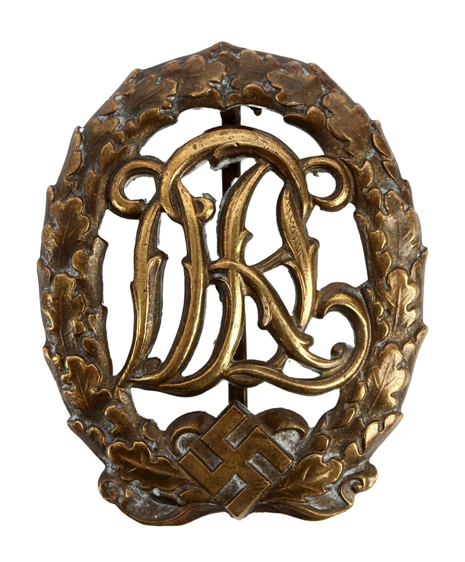WWII GERMAN THIRD REICH DRL SPORTS BADGE: A DRL sports badge. Maker Ferdinand Wagner. Overlapping 'DRL' inside a wreath over a swastika. Very good, original condition.
