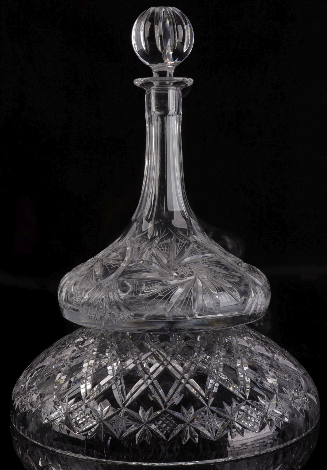 CRYSTAL SHIP STYLE DECANTER AND CRYSTAL BOWL SET: A crystal ship-style decanter with etched rose and star pattern and a crystal bowl with etched hobnail and star pattern. the decanter measures 10.5 inches from the stopper to base. The base has a