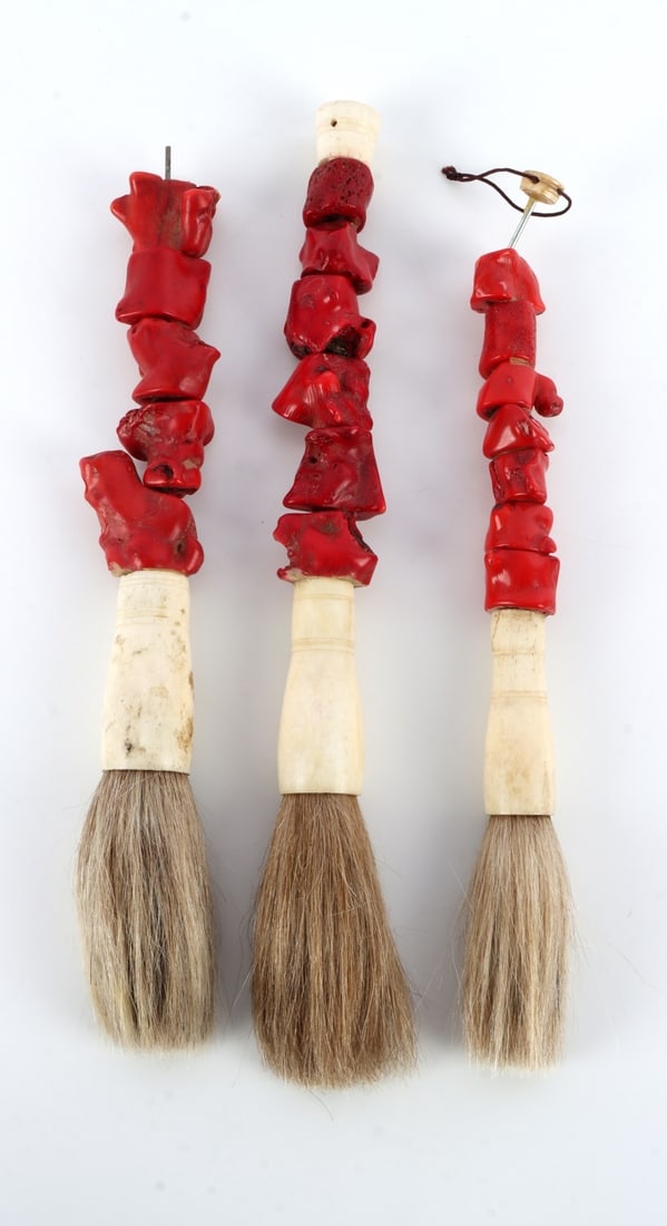 LOT OF 3 RED CORAL AND BONE CALLIGRAPHY BRUSHES: Segmented red coral with bone holders for the horse hair brushes. They measure 12 1/8 inches.