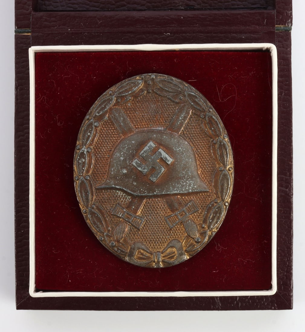 WWII GERMAN CASED WOUND BADGE IN GOLD: Reverse has vertical thin wire pin and is stamped "5." Very good condition. Some patination.