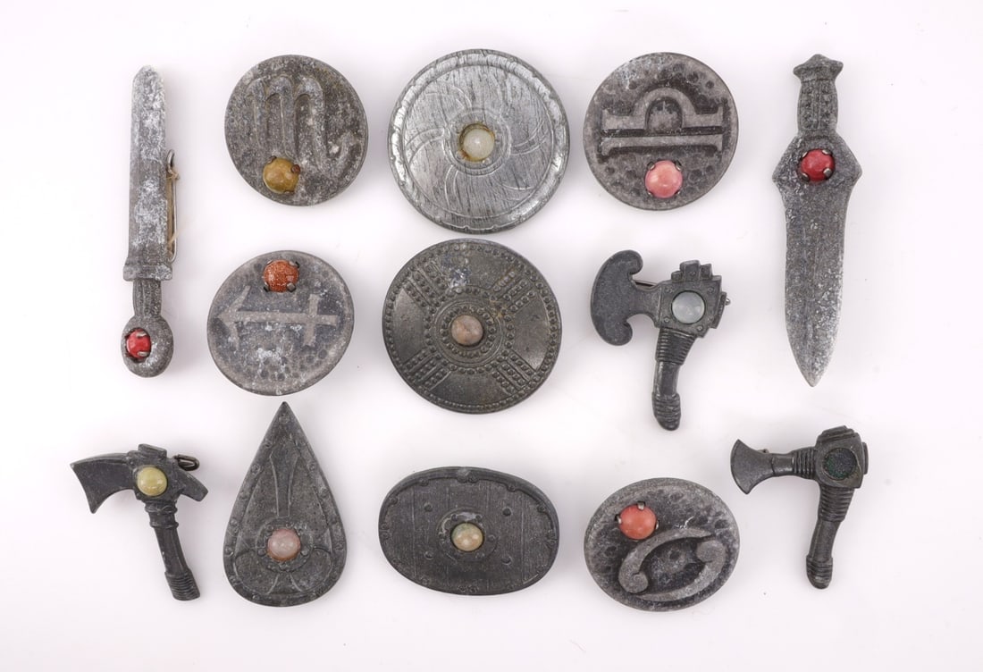 WWII GERMAN THIRD REICH NORDIC TINNIES LOT OF 13: Third Reich badges in the form of Nordic war shields, swords and axes. Some are plastic, some are steel. Measure 1-2 inches. Maker marks on back. Unauthenticated, sold as is.