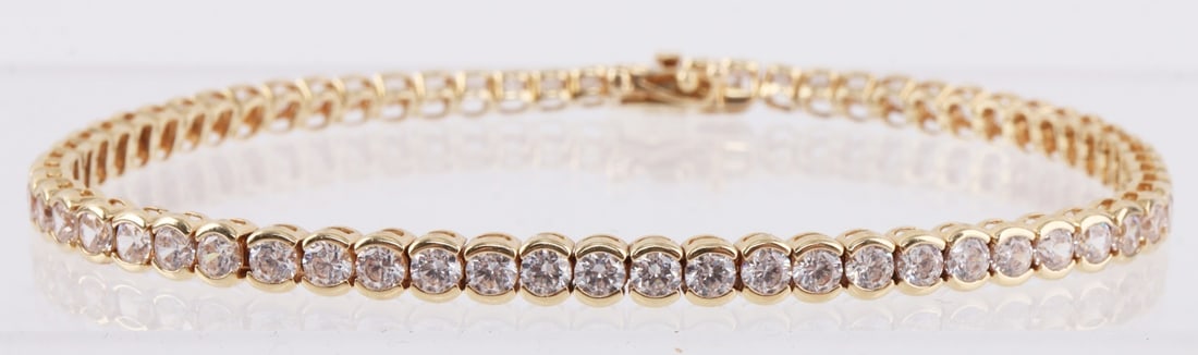 14K YELLOW GOLD TENNIS BRACELET CZ 2.3MM: Stamped "14K CZ" total weight 7.198 grams. In very good condition without damage to stones or bezel settings. Excellent piece for travel or everyday wear. Functional and secure clasp. Measures 7 inche