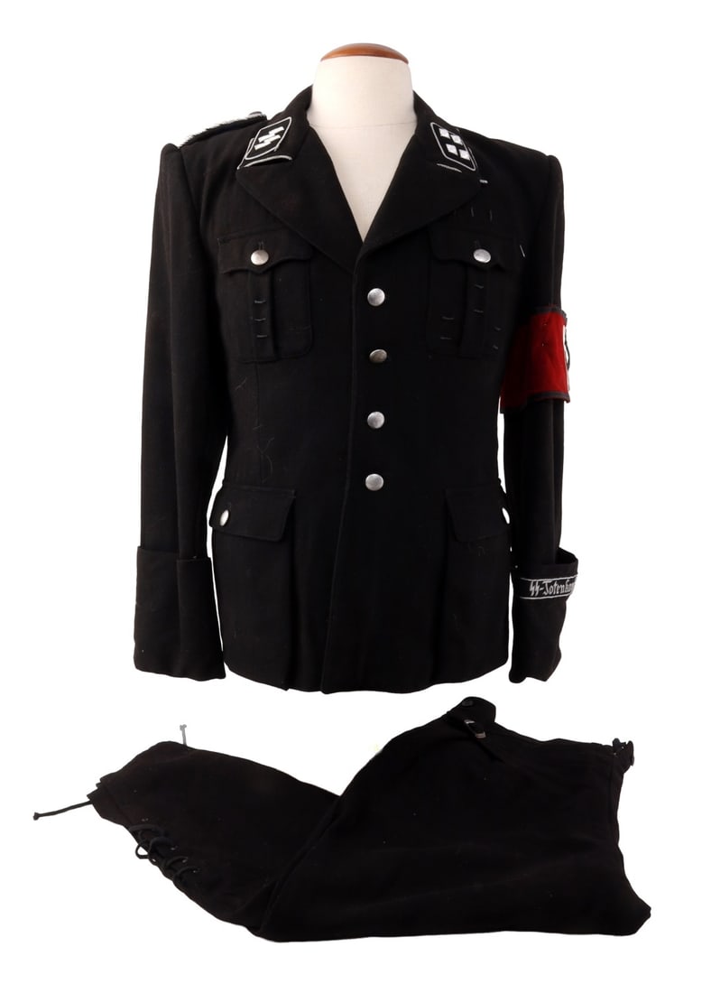 NAMED WWII GERMAN ALLGEMEINE SS UNIFORM: Black wool construction. Collar tabs with SS runes in bullion thread. Similar thread featured on collar and zig-zag stitch pattern. Pebbled buttons are aluminum with steel backing and marked Assmann.