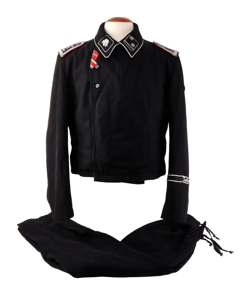 WWII GERMAN PANZER NCO WRAP AND TROUSERS: German Panzer NCO Wrap and Trousers. Late WWII. Wool tunic with Totenkopf collar tabs and NCO rank insignia. The left sleeve displays a bullion-threaded Reichsadler and a "Totenkopf" division cuff tit