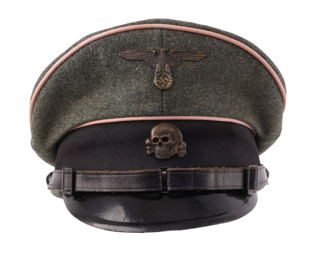 NAMED WWII GERMAN WAFFEN SS PANZER OFFICER VISOR: Field green wool visor with Bevo style black band. Leather chin strap. Bronzed Totenkopf and Reichsadler. Hard leather visor. Leather sweatband. Silk liner. Size 57. Gruppe West D.R.P.