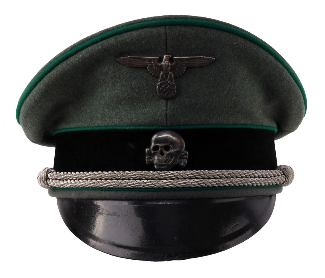 WWII GERMAN SS MOUNTAIN TROOP NCO VISOR CAP: WWII German Waffen SS Mountain NCO visor cap. Field green wool with dark green piping and black velvet band. Visor is hard leather. Chin strap is typical bullion fashion. Reichsadler and Totenkopf are