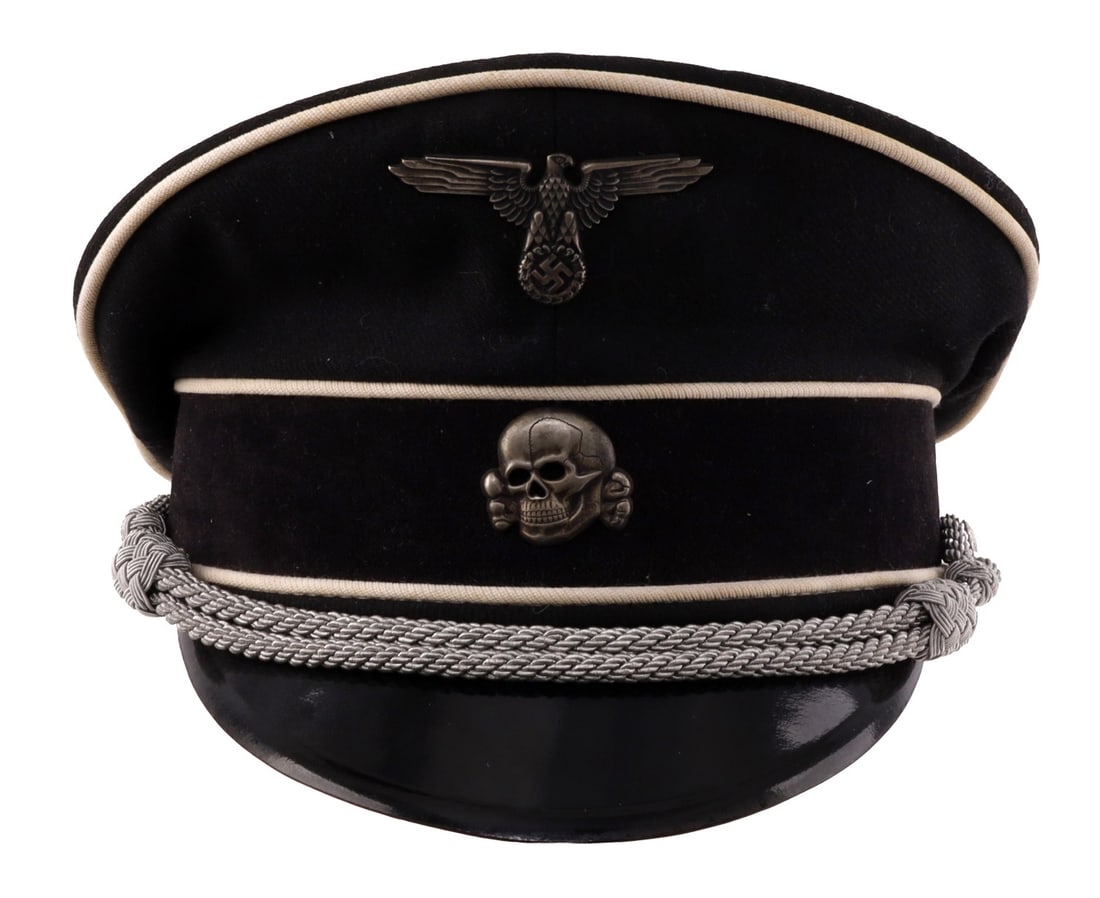 WWII GERMAN SS OFFICER VISOR NAMED DACHAU: A visor for the Allgemeine-SS of the German Third Reich. Black wool construction with white piping and a black velvet band. Hard leather visor with 'SS' ink stamp. Silver bullion strap indicates junio