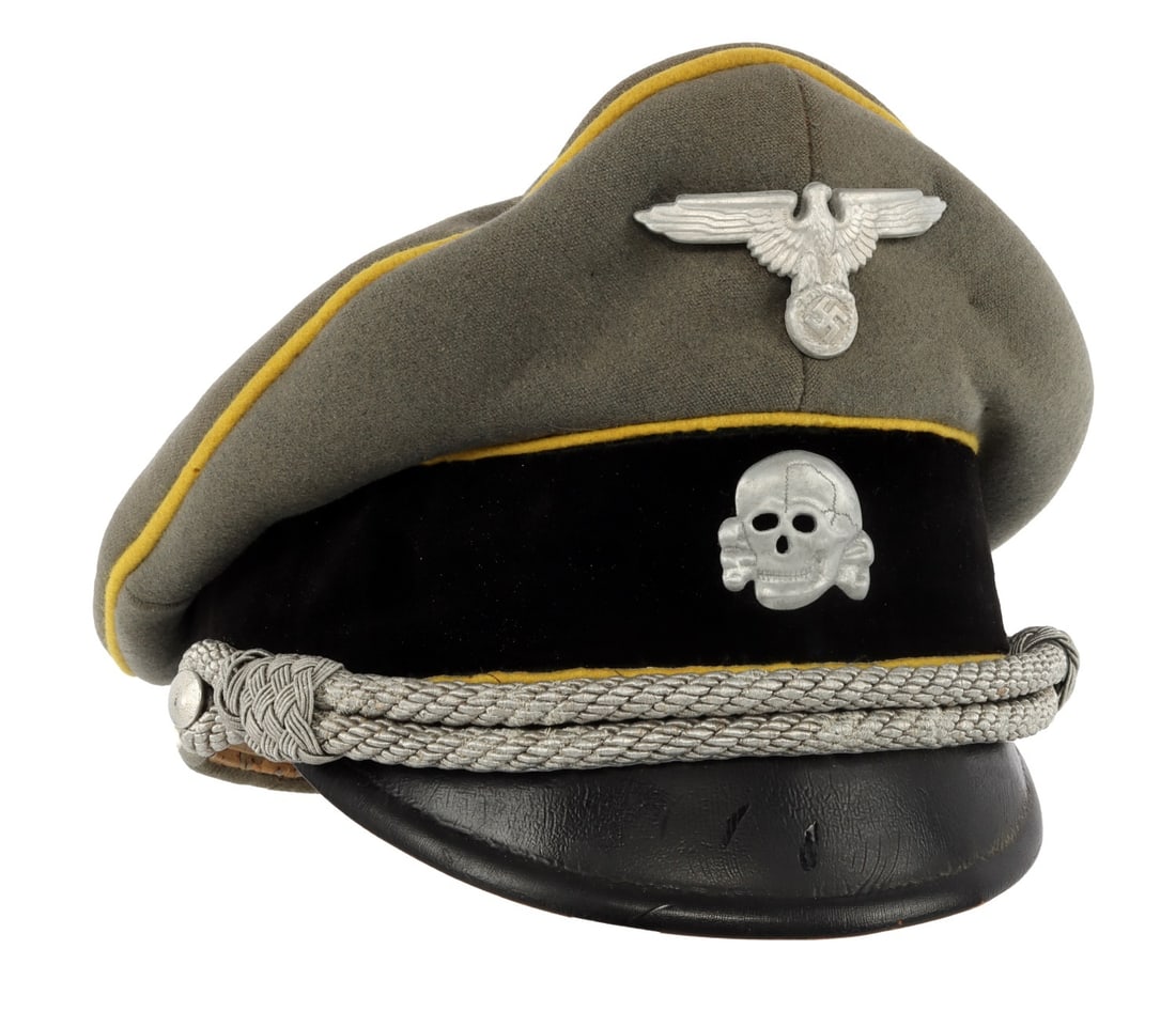 WWII GERMAN WAFFEN SS CAVALRY VISOR: The cap is constructed of grey wool with a black velvet band and yellow piping. Both the Reichsadler and Totenkopf pins are fashioned from aluminum, and the chin cord consists of bullion thread. The v