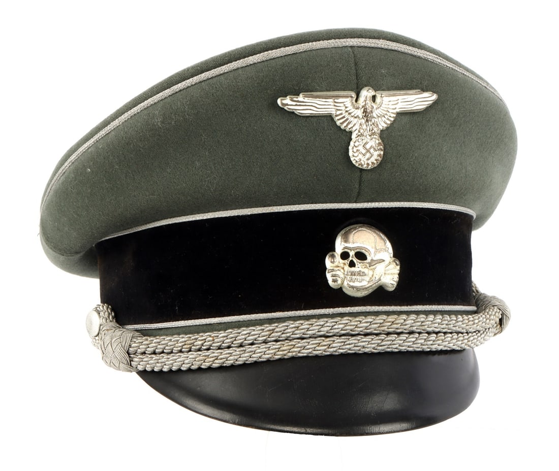 WWII GERMAN WAFFEN SS GENERALS VISOR: The Waffen-SS general’s visor cap is characterized by its distinct field-grey wool construction and high-ranking ornamentation, most notably the silver bullion piping and matching chin cord that dis