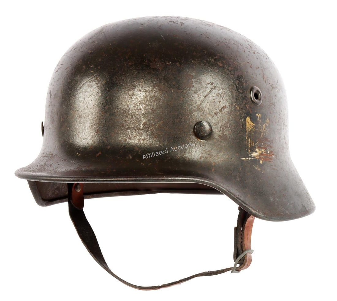 WWII KRIEGSMARINE M40 STEEL COMBAT HELMET QUIST: Kriegsmarine M40 Stahlhelm with original chinstrap and liner. Exterior painted black. Gold decal on left side. Interior stamped "1238" at neck and "Q66" at left ear. Very good condition. Decal scratch