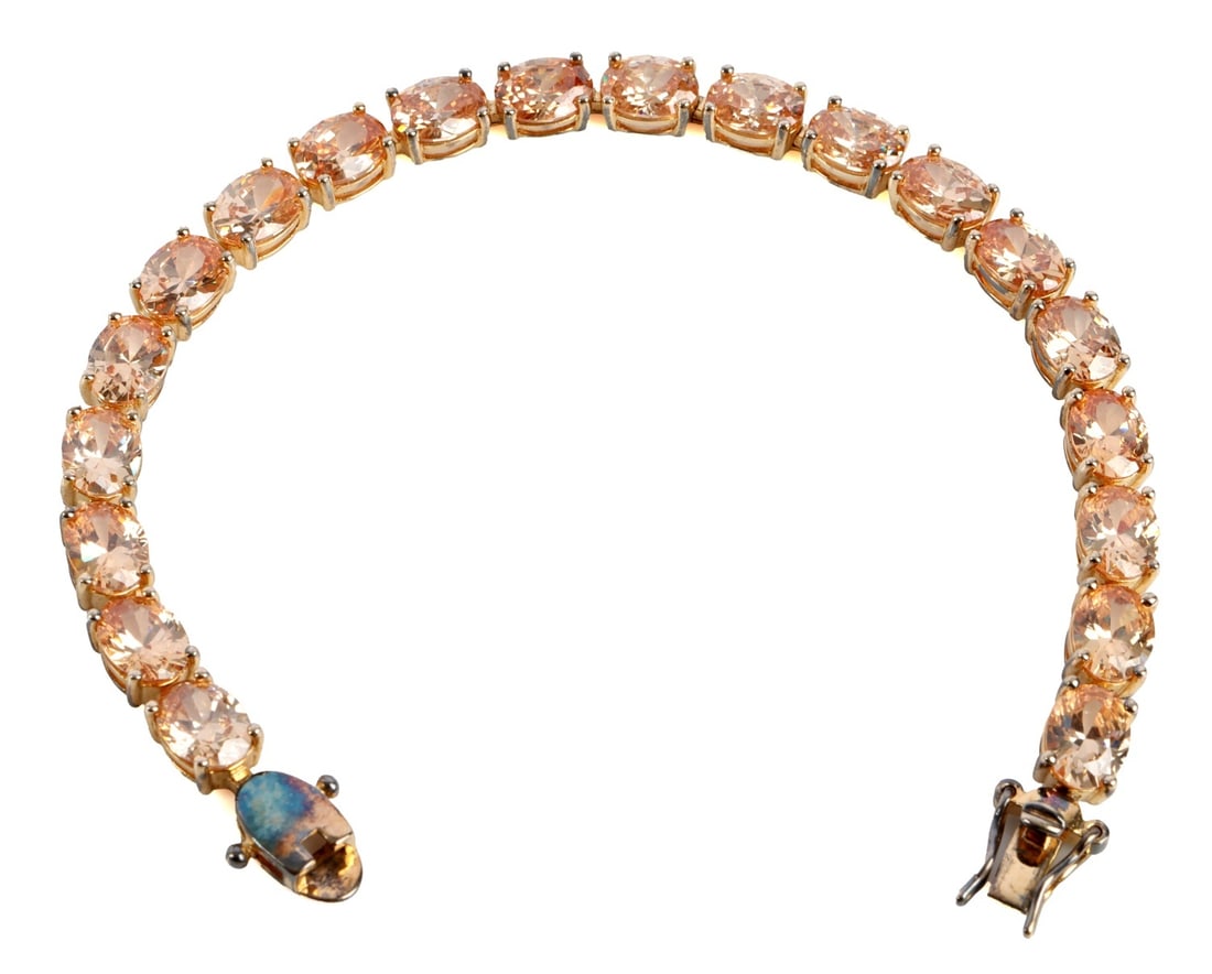 .925 STERLING SILVER TENNIS BRACELET: A .925 sterling silver tennis bracelet with yellow diamonique stones. 8 inches. This lot has a reserve.