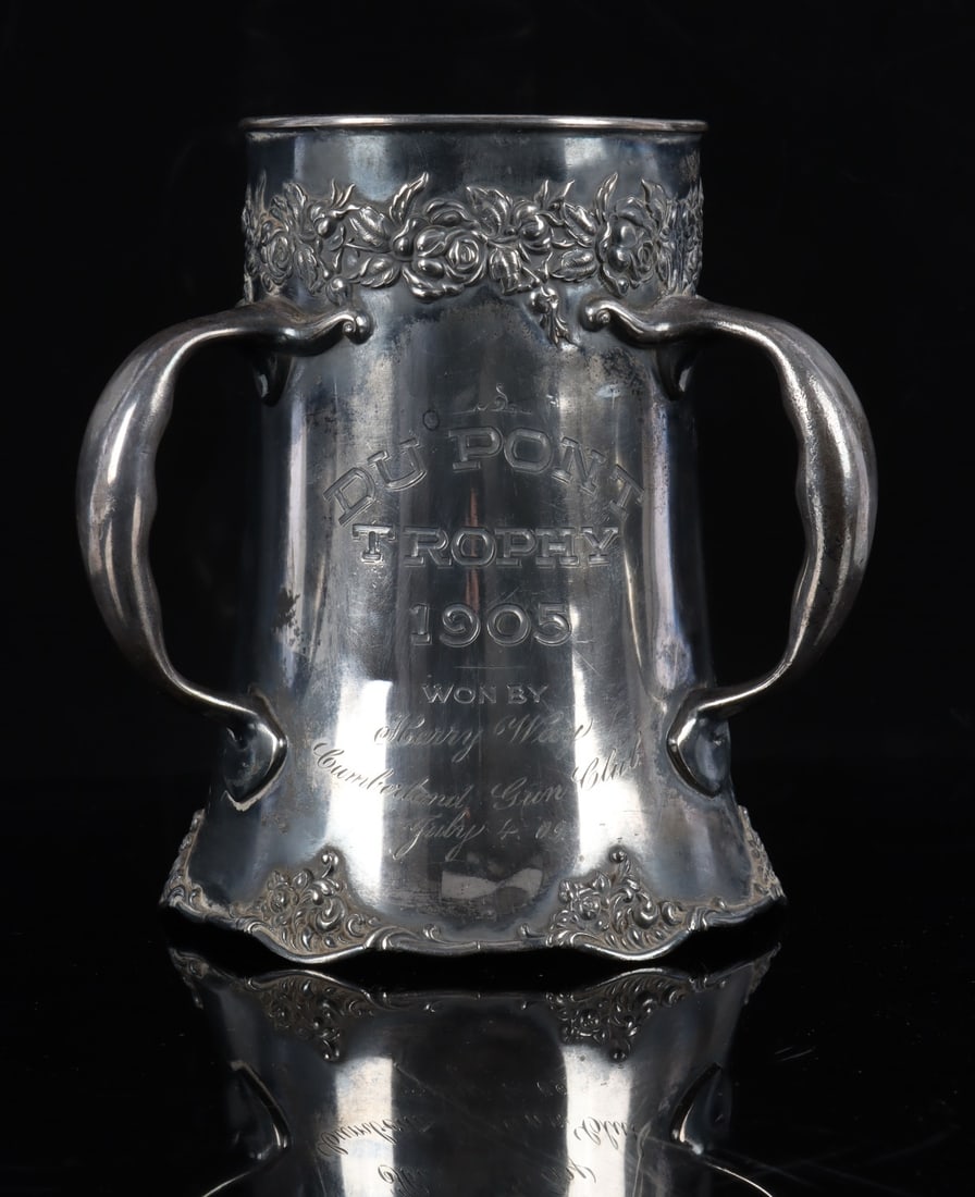 DU PONT TROPHY FOR THE CUMBERLAND GUN CLUB: A silver plate trophy marked 'Du Pont Trophy' and identifies Harry Way of the Cumberland Gun Club as its winner. There are two distinct dates on the trophy, 1905 and July 4, 1909. 10 inches tall.