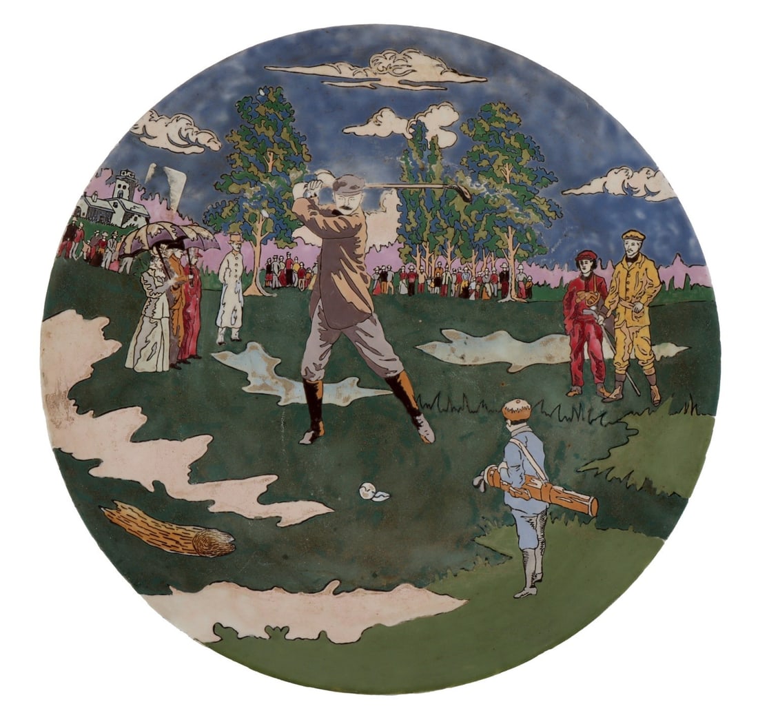 LARGE ART NOUVEAU PLATE DEPICTING A GOLF SCENE: A large art nouveau art plate depicting a man playing gold in front of several onlookers. 16.1 inch diameter. Some of the inlay is missing, but piece overall remains quite lovely. Very good, original