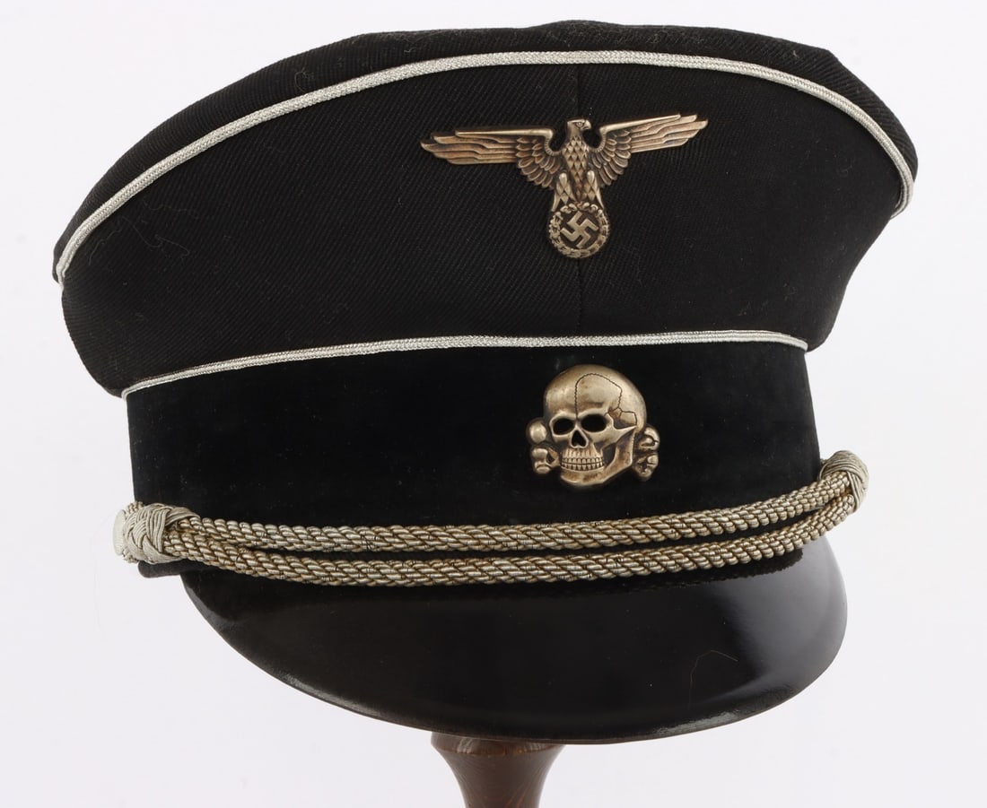 GERMAN SS PANZER OB.GRU.FUR. HERMANN PRIESS VISOR: Black gabardine with velvet band. Piping is bullion thread. Chin cord also in bullion thread. Reichsadler and Totenkopf in silver. Interior features leather sweatband. Silk lining with ink stamp 56 fo